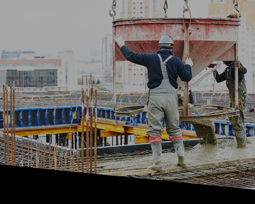 construction worker overseeing concrete pour